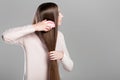 Woman combing long natural hair