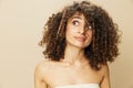 Woman combs curly afro hair with wooden comb, home care styling products, hair loss after covid-19, smile on Royalty Free Stock Photo