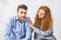 Woman comforting depressed man at rehab group meeting