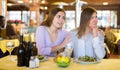 Woman comforting her upset female friend in restaurant Royalty Free Stock Photo