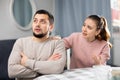 Woman comforting offended husband after spat at home