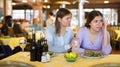 Woman comforting upset female friend during dinner in restaurant Royalty Free Stock Photo