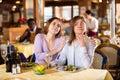 Woman comforting upset female friend during dinner in restaurant Royalty Free Stock Photo