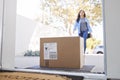 Woman Coming Back To Home Delivery In Cardboard Box Outside Front Door Royalty Free Stock Photo