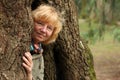 Woman coming out of tree