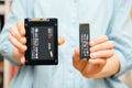 Woman compare new NVME drive disk with SSD drive disk