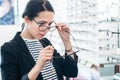 Woman comparing glasses at optician