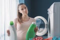Woman comparing laundry detergents and thinking
