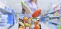 Woman comparing products at the supermarket Royalty Free Stock Photo