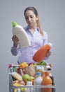 Woman comparing products at the supermarket Royalty Free Stock Photo