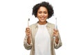 woman comparing wooden and electric toothbrushes Royalty Free Stock Photo