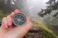Woman with compass is seeking a right way in forest Royalty Free Stock Photo