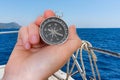 Woman with compass is seeking a right way on sea Royalty Free Stock Photo