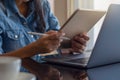 Young asian business woman hands holding electronic pen  stylus pen  and working on digital tablet pc with laptop computer. Royalty Free Stock Photo