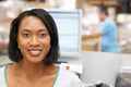 Woman At Computer Terminal In Distribution Warehouse