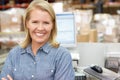 Woman At Computer Terminal In Distribution Warehouse