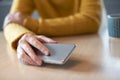 Woman Concerned About Excessive Use Of Social Media Laying Mobile Phone Down On Table