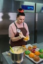 Woman confectioner adding creamy or cheese filling into the choux au craquelin Royalty Free Stock Photo