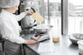 Woman confectioner working at the bakery manufacturing