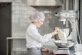 Woman confectioner working at the bakery manufacturing