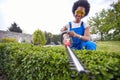 Boundaries Redefined: A Woman's Flourish in Trimming a Living Hedge Royalty Free Stock Photo