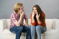 Woman confiding to man on sofa Royalty Free Stock Photo