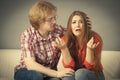 Woman confiding to man on sofa