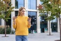 Woman confused by credit card issue while using phone outdoors