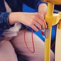 A woman connects a telephone wire on the bus. Mobile phone charger with usb in public transport Royalty Free Stock Photo