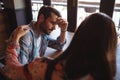 Woman consoling man at counter Royalty Free Stock Photo