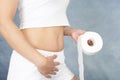 Woman with a roll of toilet paper