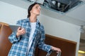 Woman construction manager inspecting opening on ceiling