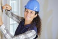 woman construction worker chipping away plaster
