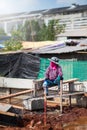 Woman construction worker waiting for plasterer mortar on the cement ,Bangkok Thailand 10 febuary 18