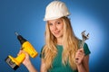 Woman with constructor helmet and tools happy to do tough work.