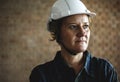 Woman constructor wearing hard helmet