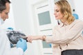 Woman consulting with dentist looking at x-ray