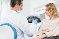 Woman consulting with dentist looking at x-ray