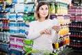 woman consulting shopping list in supermarket Royalty Free Stock Photo