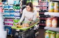 woman consulting shopping list in supermarket Royalty Free Stock Photo