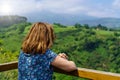 Woman contemplating the green valley from a viewpoint with flashes of the sun on the horizon. Santander Royalty Free Stock Photo