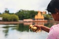 Woman Pouring Water From Brass Faucet at Hindu Ritual in Mauritius