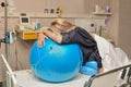 Woman during contractions on a fitness ball Parturition hospital Royalty Free Stock Photo
