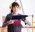 Woman contractor with hand drill at construction site Royalty Free Stock Photo