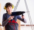 Woman contractor with hand drill at construction site Royalty Free Stock Photo