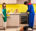 Woman with contractor at kitchen discussing repair Royalty Free Stock Photo