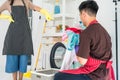 woman control man to wash clothes at laundry Royalty Free Stock Photo