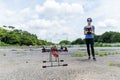 Woman controlling flying drone at outdoor