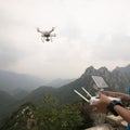 Woman controlling flying drone