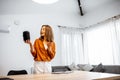 Woman controlling home devices with a voice commands